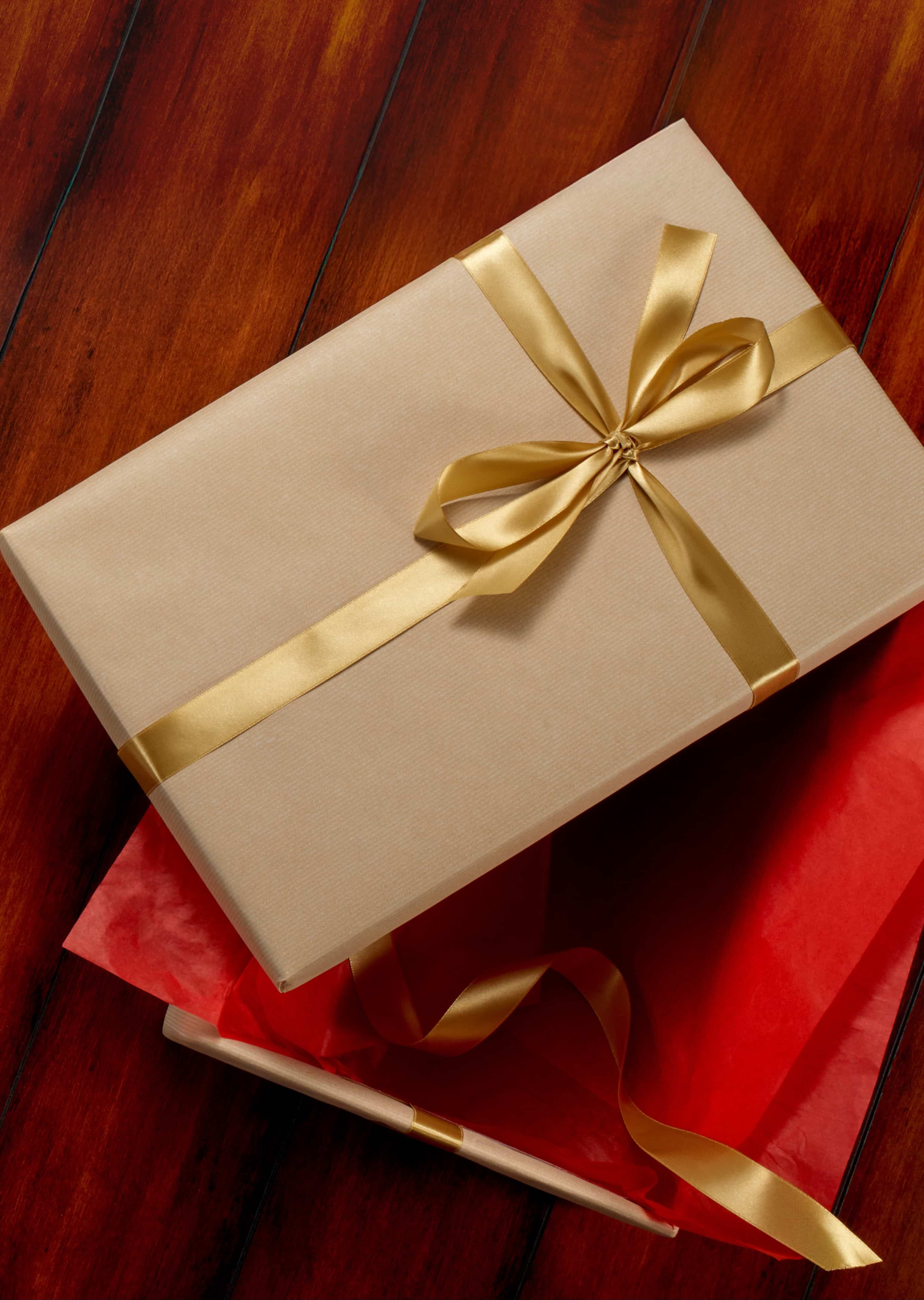 The featured image is a model wearing black Stacy Adams slip on shoes, black striped pants, and a white and black sweater while sitting on the floor with a blue abstract background.