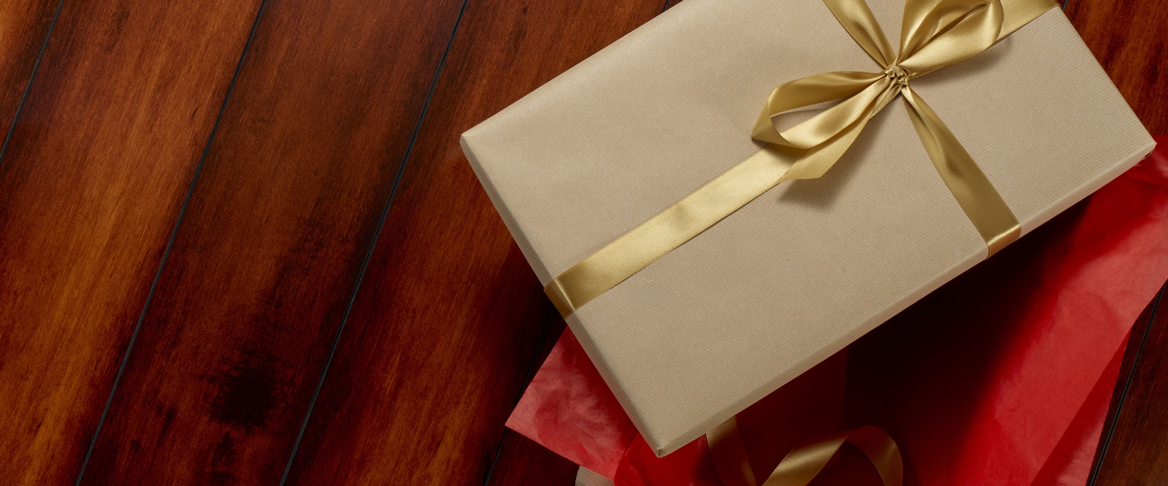 Shop our Cyber Monday sale featuring a stack of gifts on a wood background.