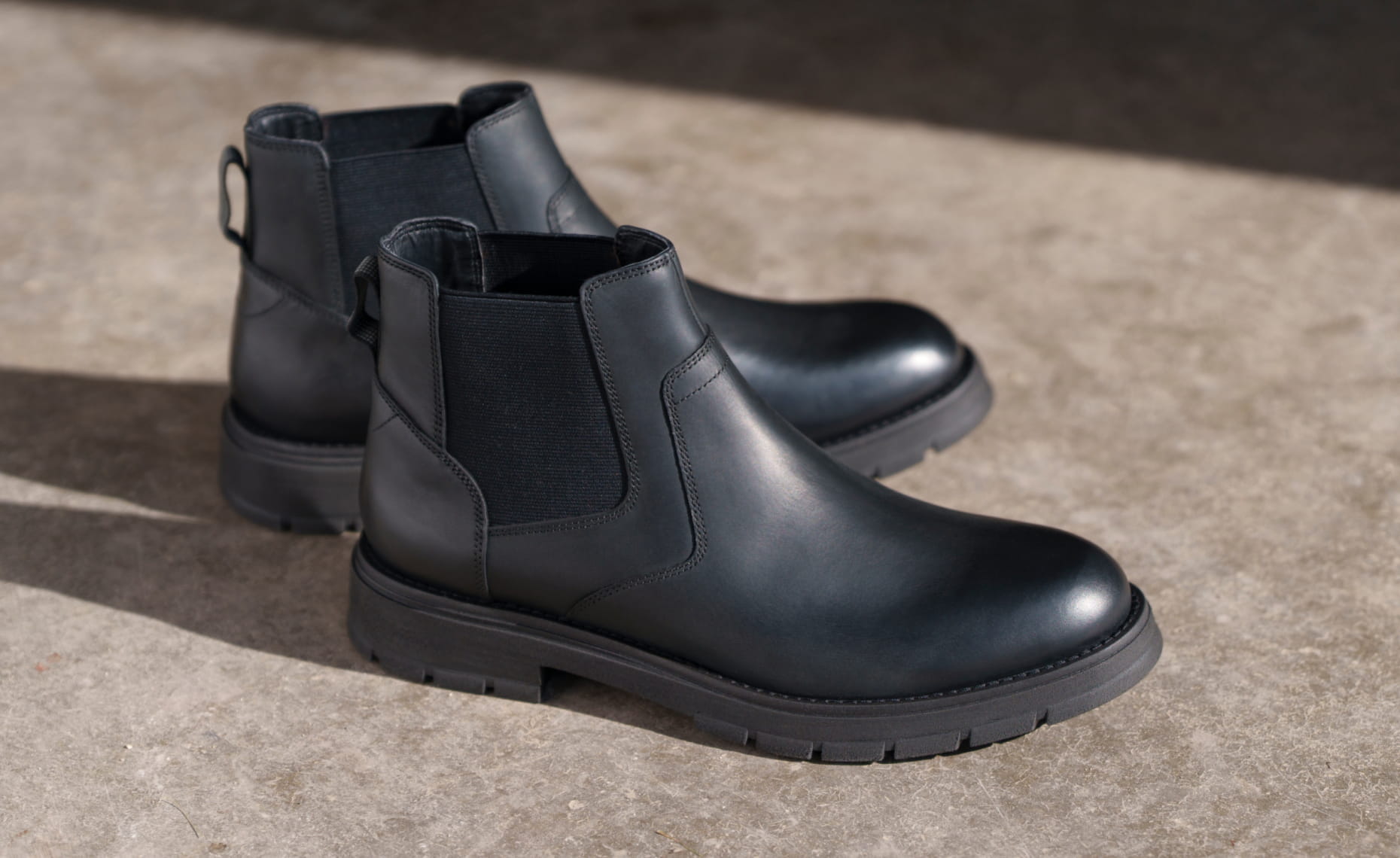 Shop Nunn Bush Boots featuring the Briggs Plain Toe Chelsea Boot in Black Waxy on concrete flooring.