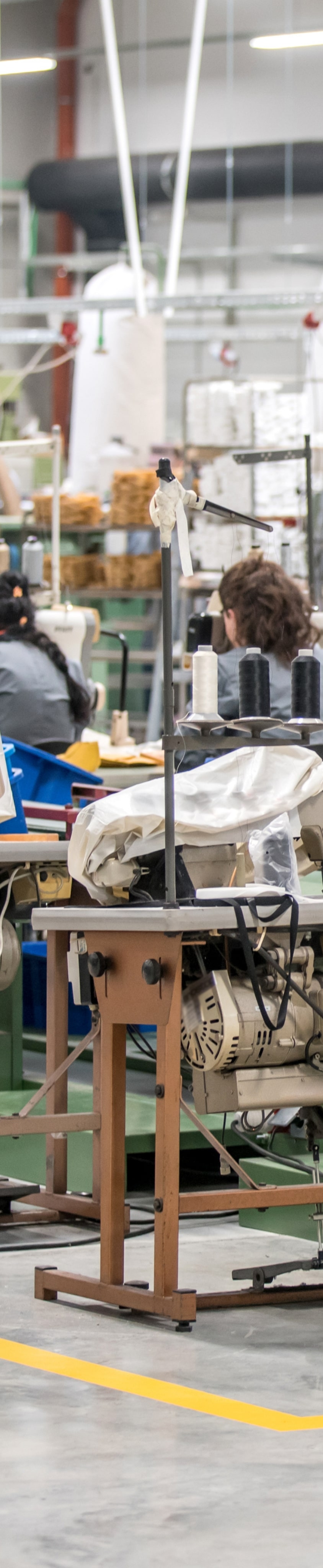 The image is of a sewing equipment inside a factory. 