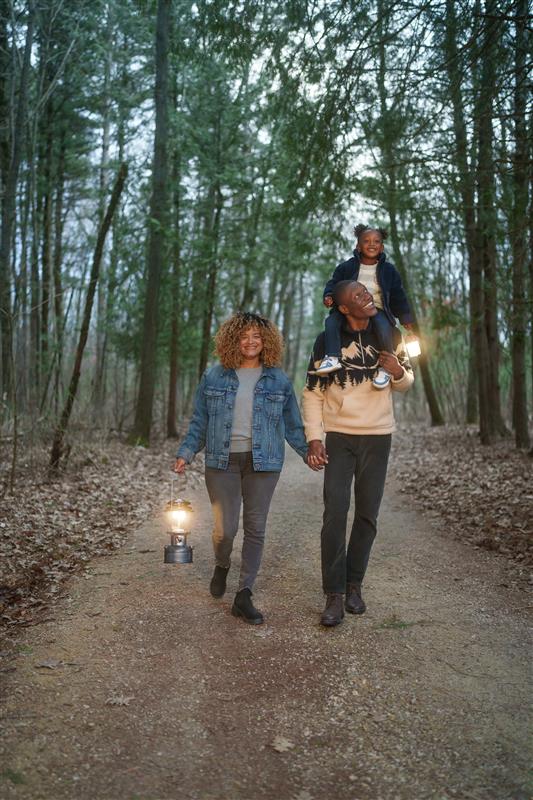 The featured image is a model wearing black Stacy Adams slip on shoes, black striped pants, and a white and black sweater while sitting on the floor with a blue abstract background.