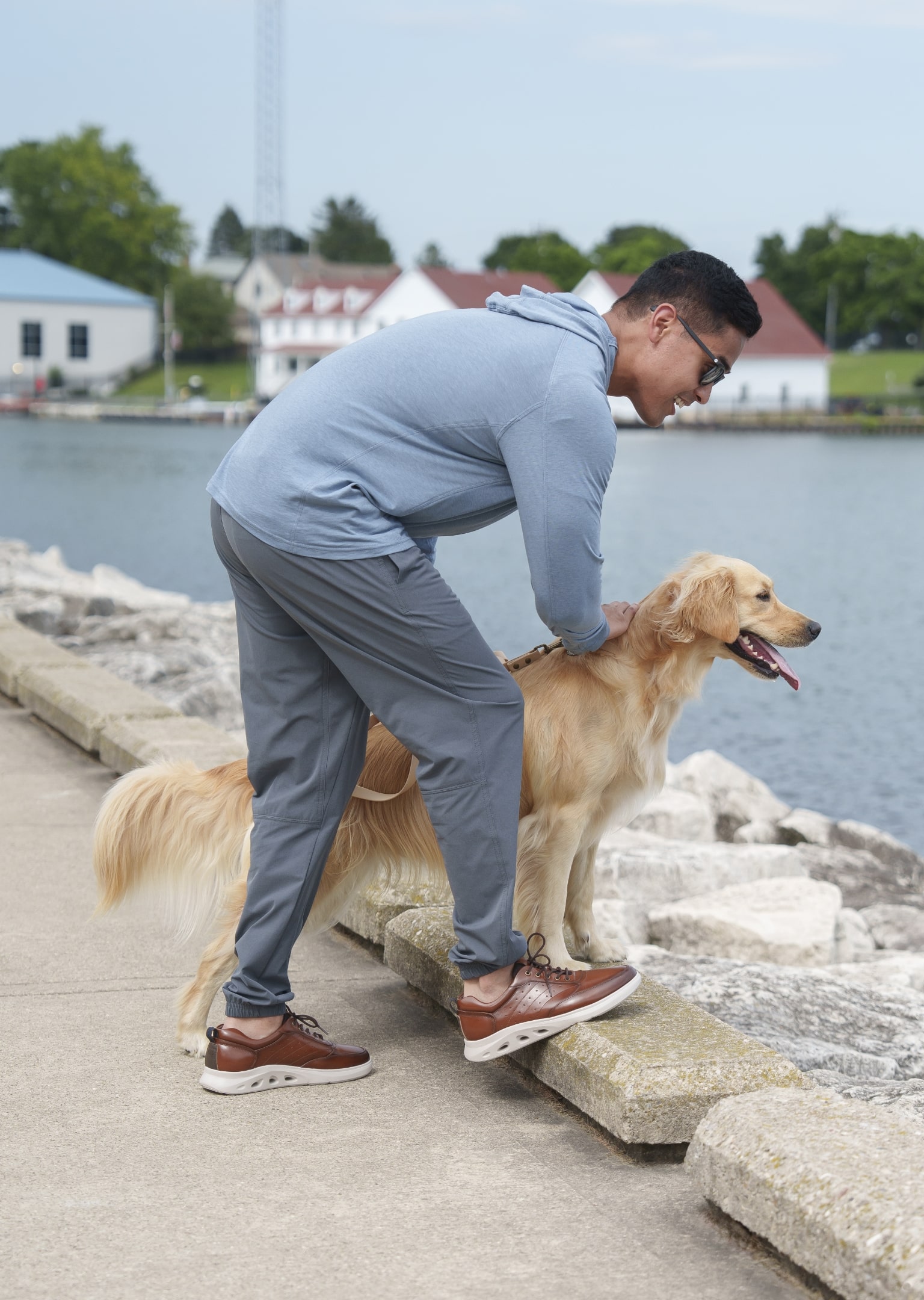 The featured image is a man wearing Nunn Bush shoes while looking out at a body of water with his dog.
