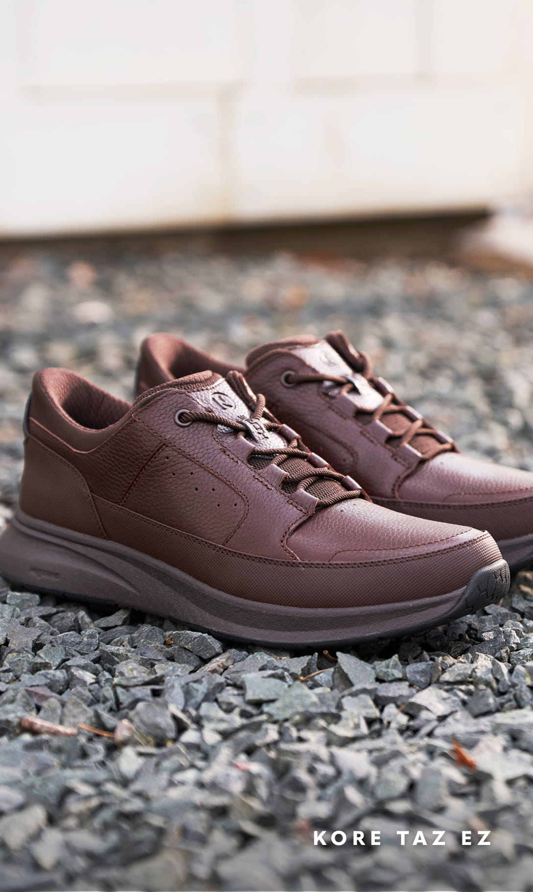 Men's Casual Shoes category Image features the Taz EZ Oxford in brown on gravel.