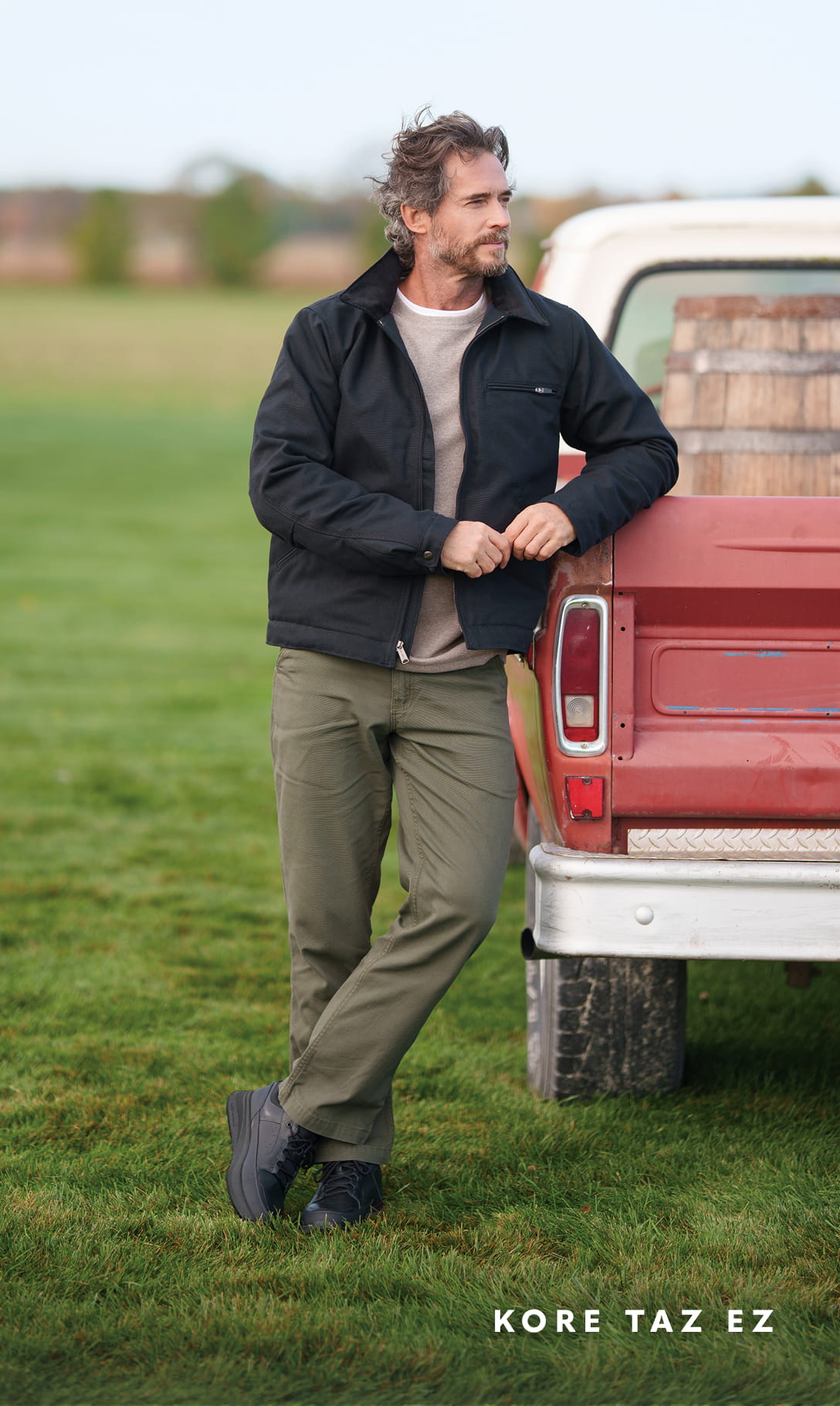 Men's Newest Shoes category Image features a man wearing the KORE Taz EZ leaning on a red truck.