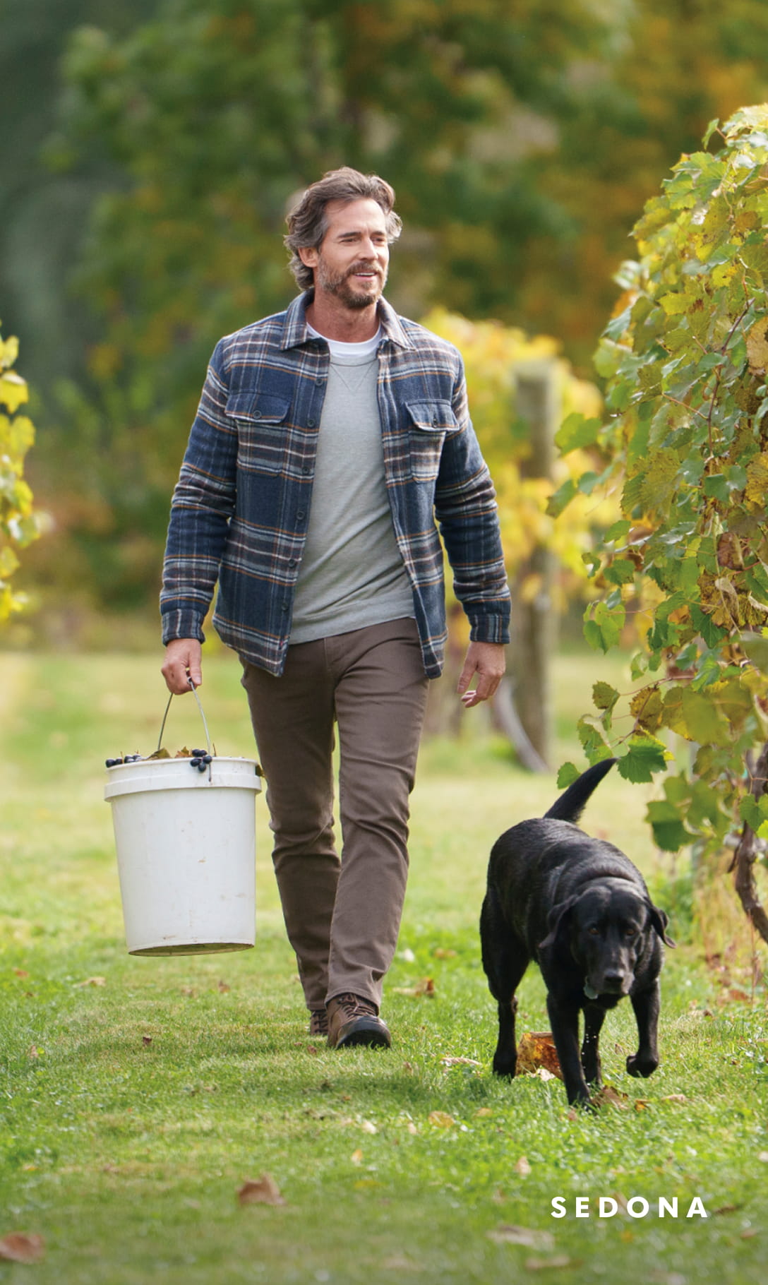 Men's Newest Shoes category Image features the Sedona boot in an orchard with a dog. 