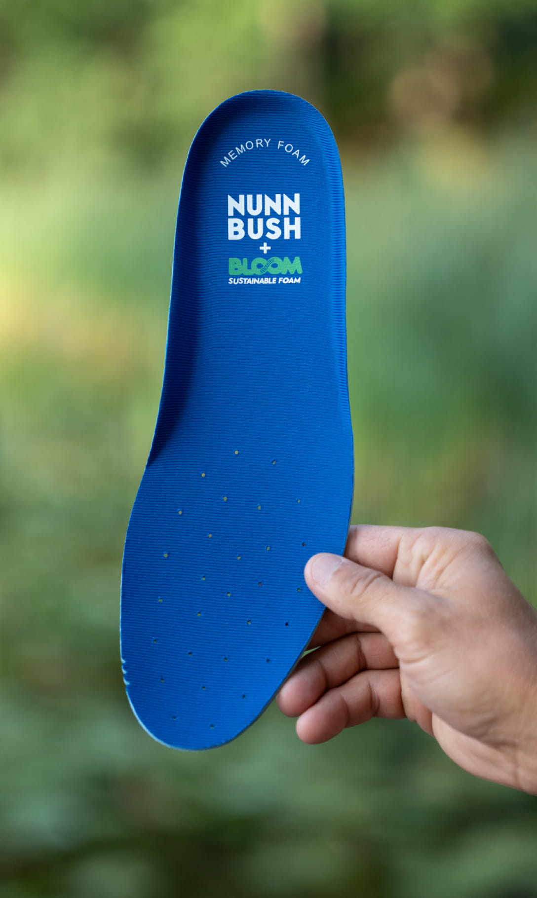 Sustainable Shoes  Image features the Bloom footbed with a blurred green background.