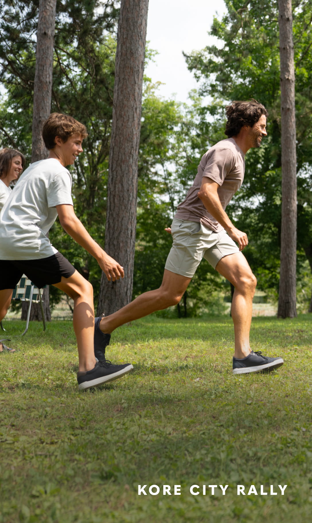 - Image features a man playing soccer in his navy blue KORE City Rally sneakers.