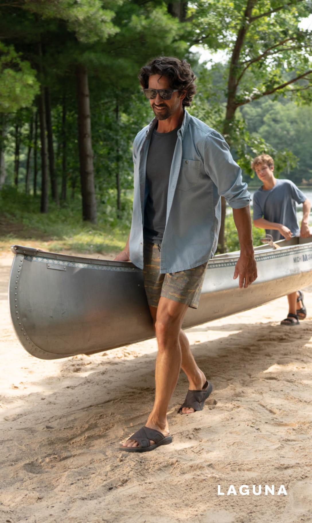 Men's Sandals category. Image features a man and son carrying a canoe in sandals.
