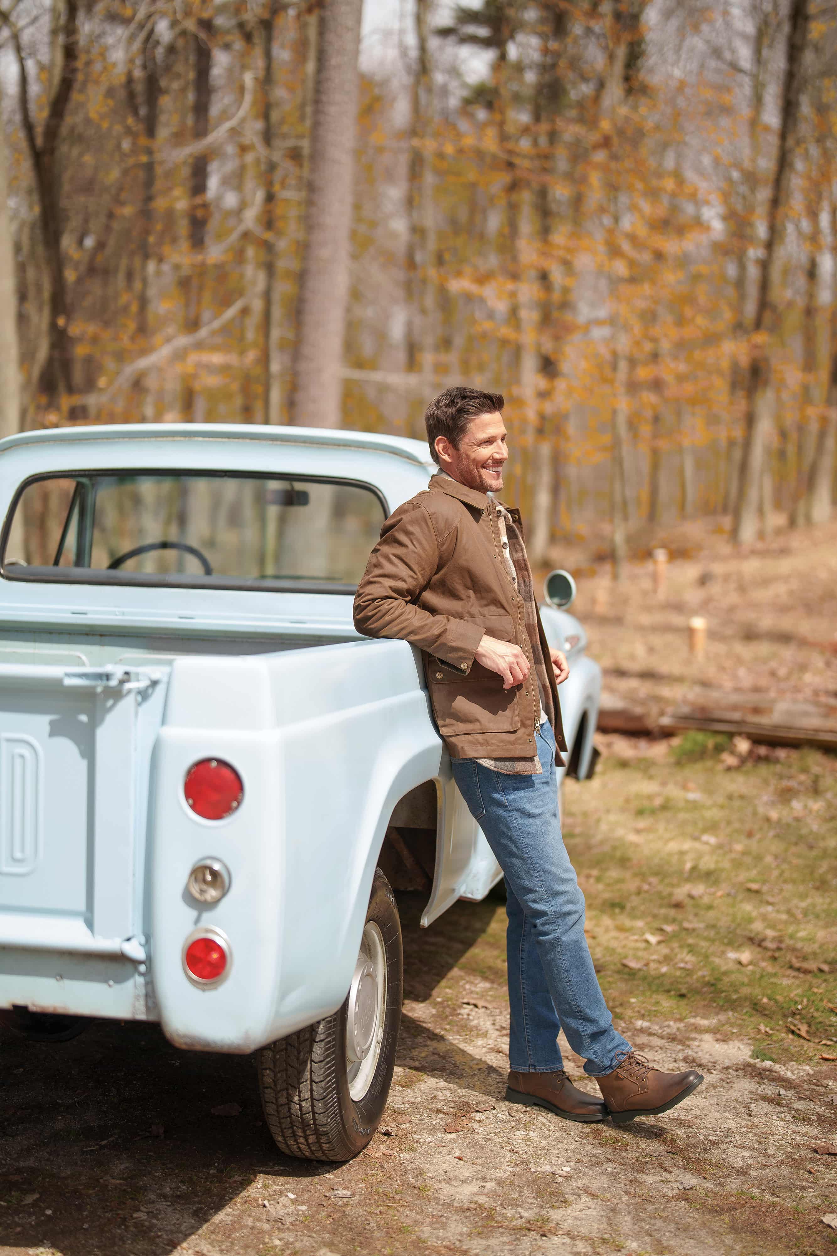 The featured image is a man wearing Nunn Bush boots while leaning on a pickup truck in the woods.