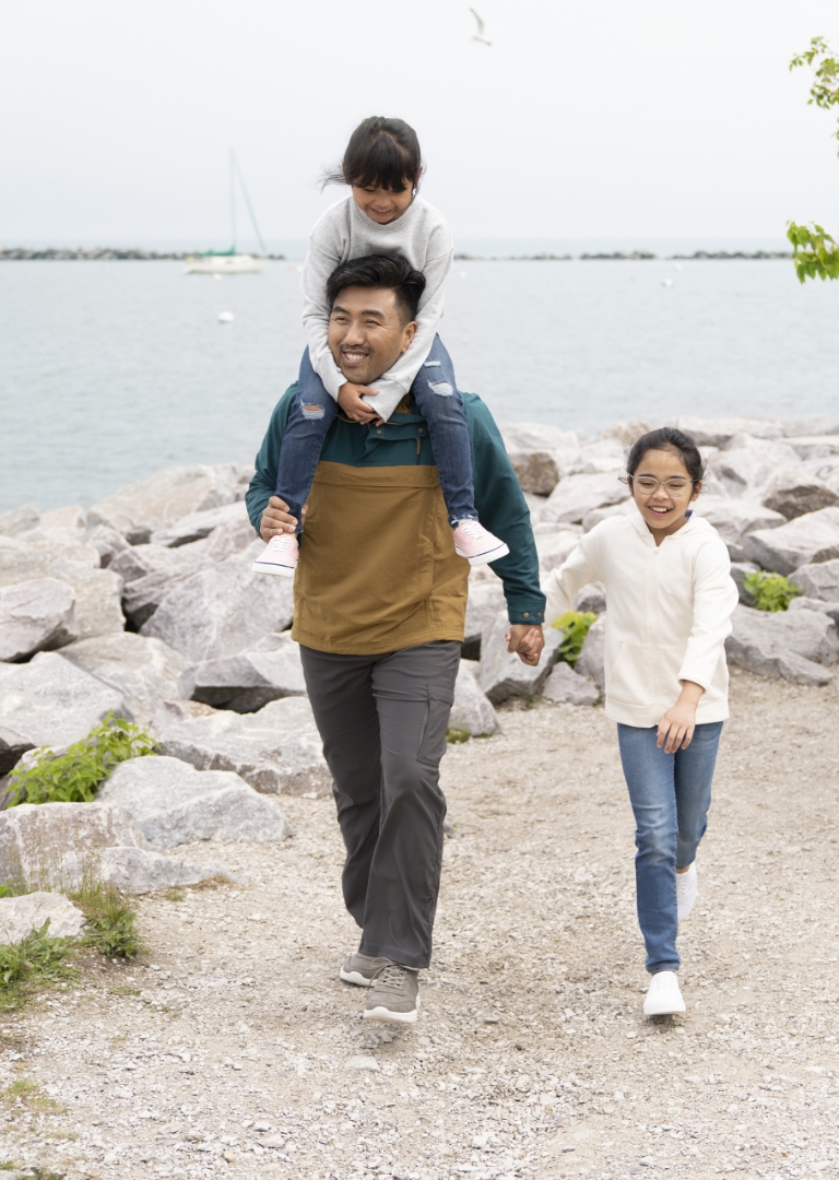 The featured image is a man wearing Nunn Bush shoes while walking alongside a lake with his children.
