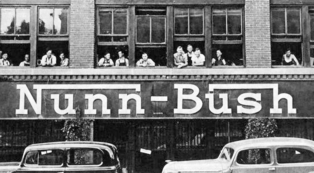 The featured image is a photograph of a Nunn Bush factory from the early 1900s.