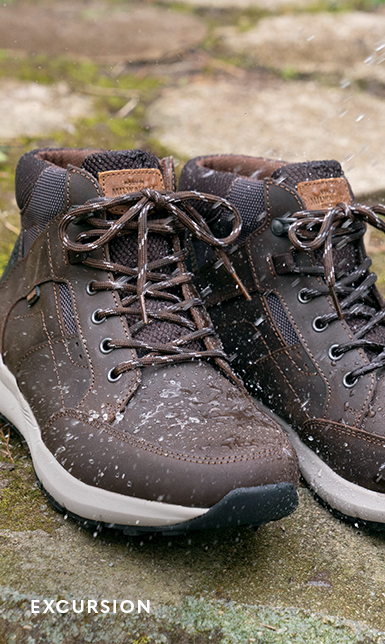 Men's Boots category. The featured product is the Excursion Moc Toe Chukka in Brown Crazy Horse leather.