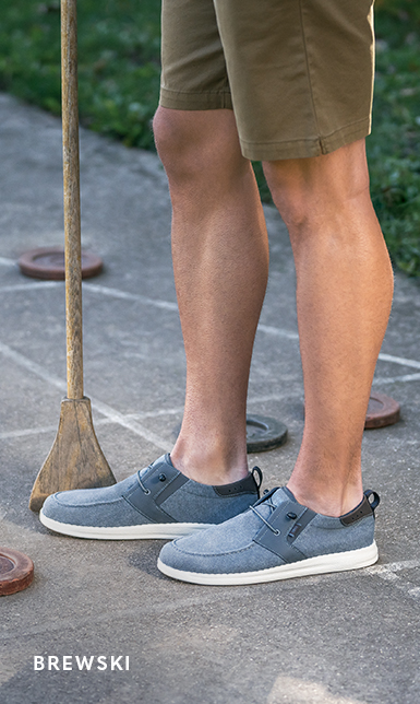 Men's Casual Shoes category. The image features the Brewski Moc Toe Wallabee in Navy.